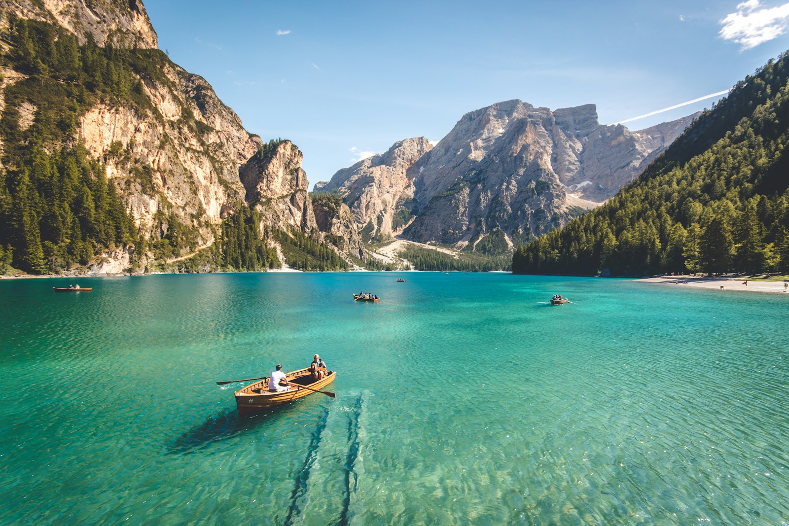 Photo by Pietro De Grandi three brown wooden boat on blue lake water taken at daytime